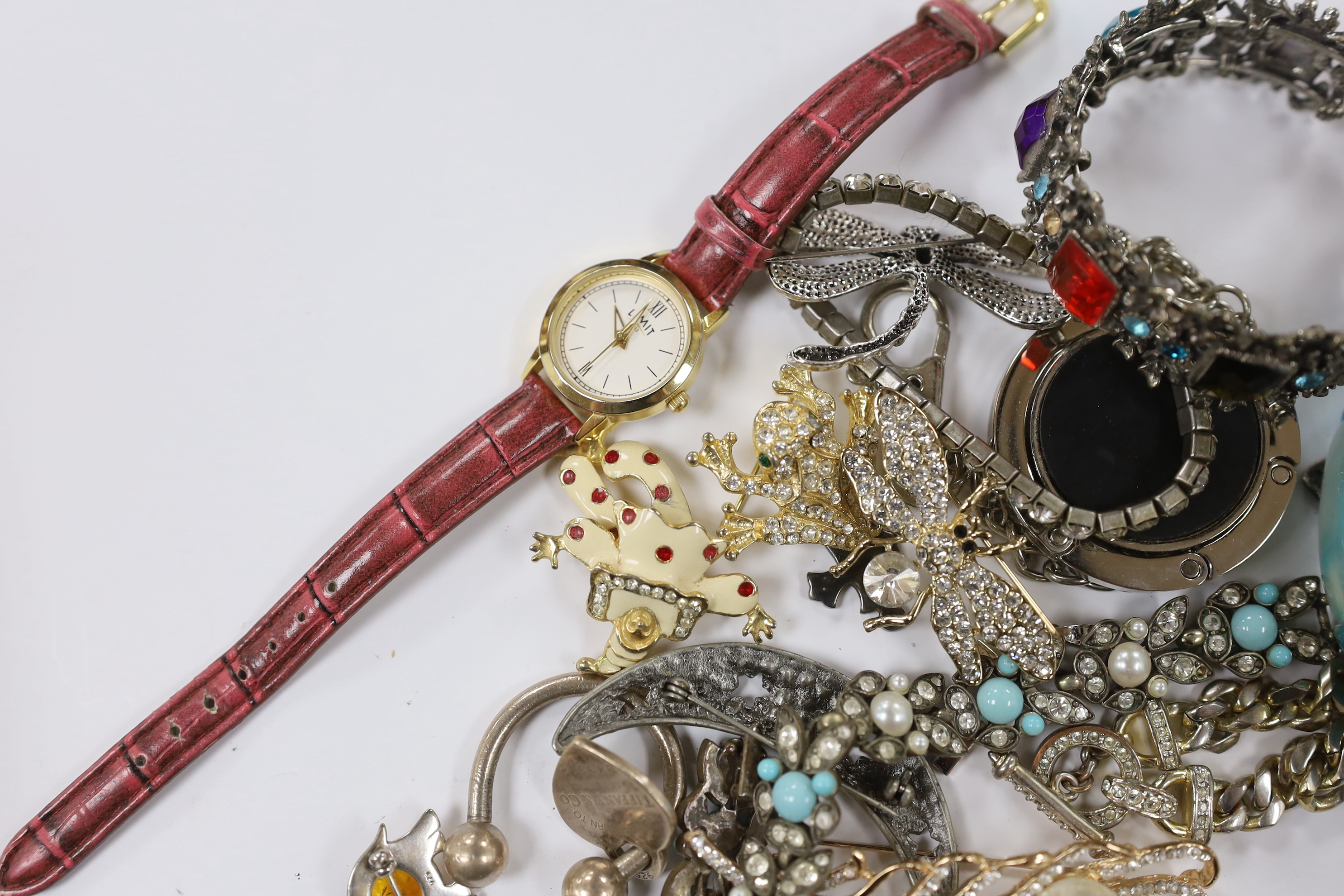 A group of assorted costume jewellery including marcasite and paste set, a Tiffany & Co sterling key ring, a 925 and amber set elephant brooch, blue agate bracelet, wrist watches, travelling watch, etc.